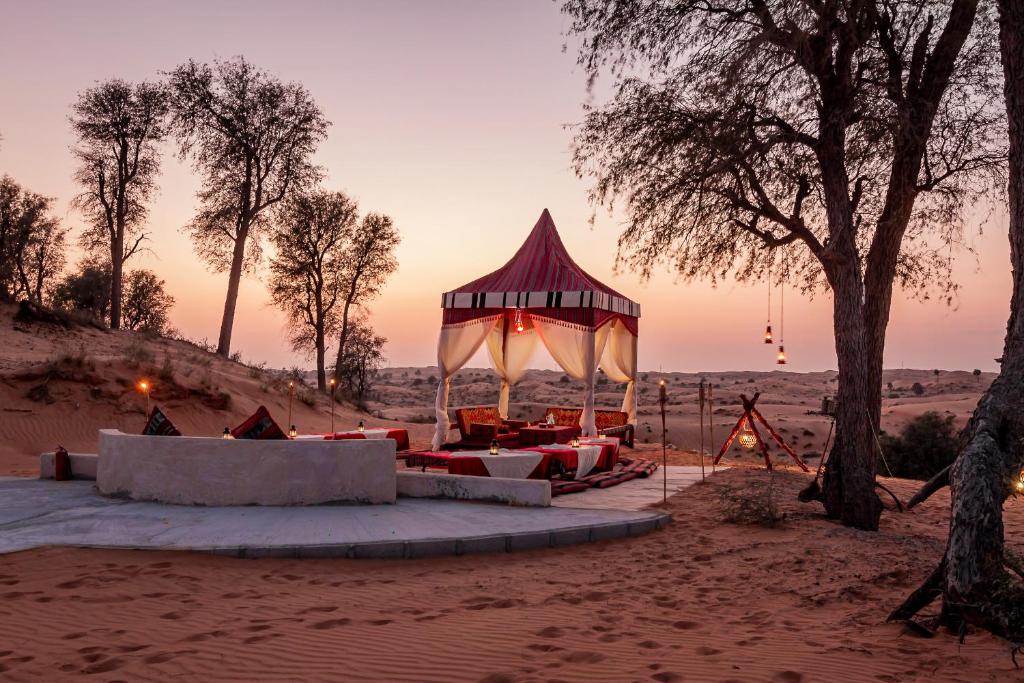 Experience a cozy Bedouin-style seating arrangement in the beautiful desert landscape at Bedouin Oasis Desert Camp.